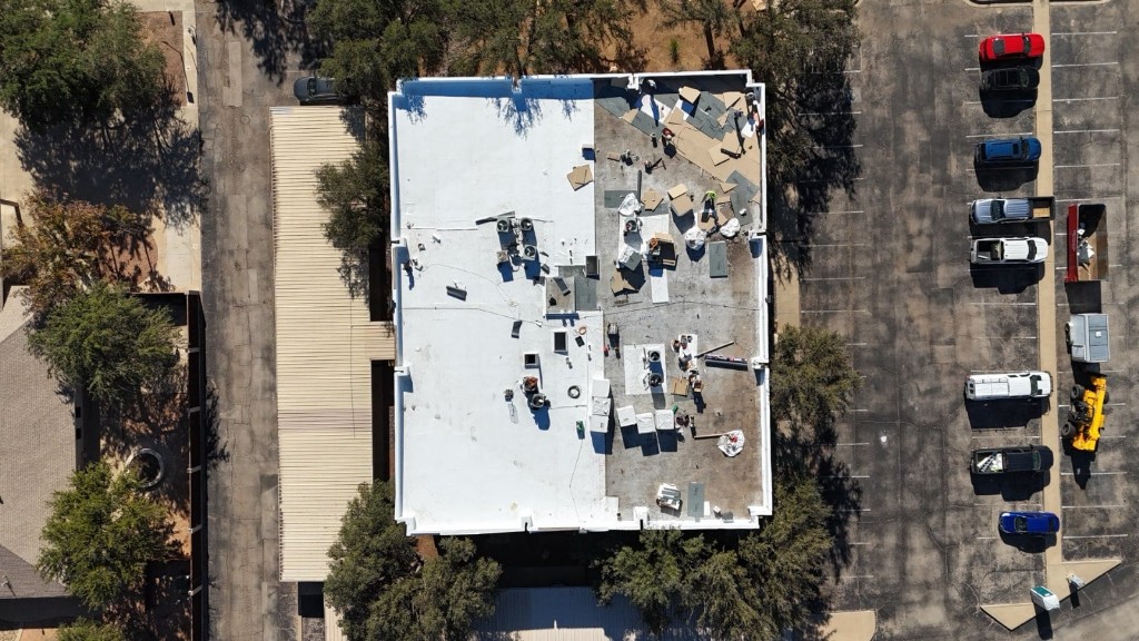 Aerial view of insulation boards and white TPO membrane installed over the existing built-up roof