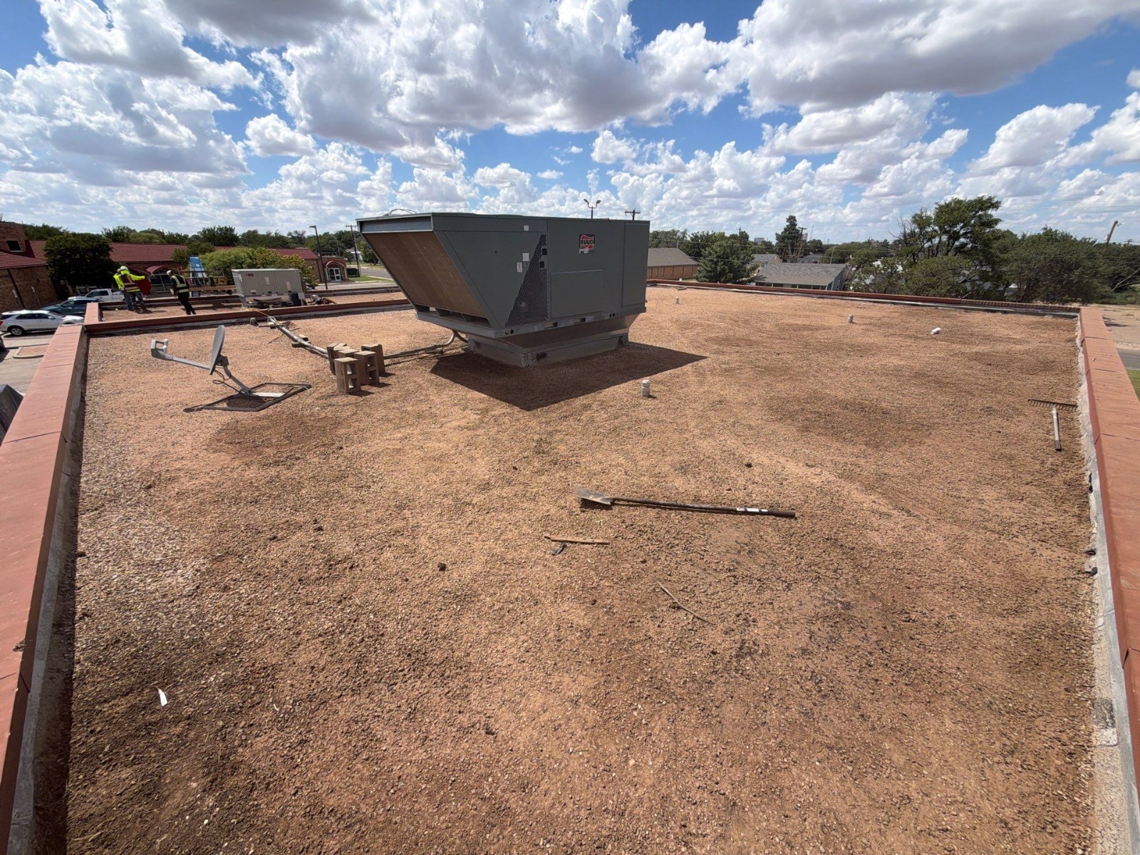 Existing gravel-surfaced built-up roof and a large rooftop unit at Copper Rawlings Senior Center