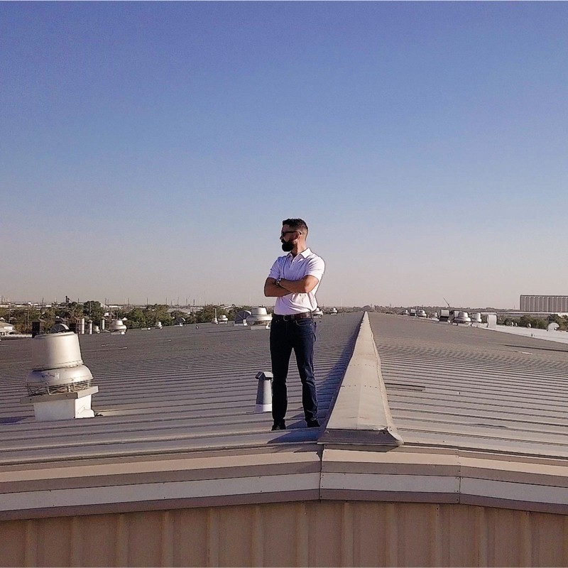 Zac Ammons, founder of Core Commercial Roofing and Coatings, on a commercial metal roof in West Texas