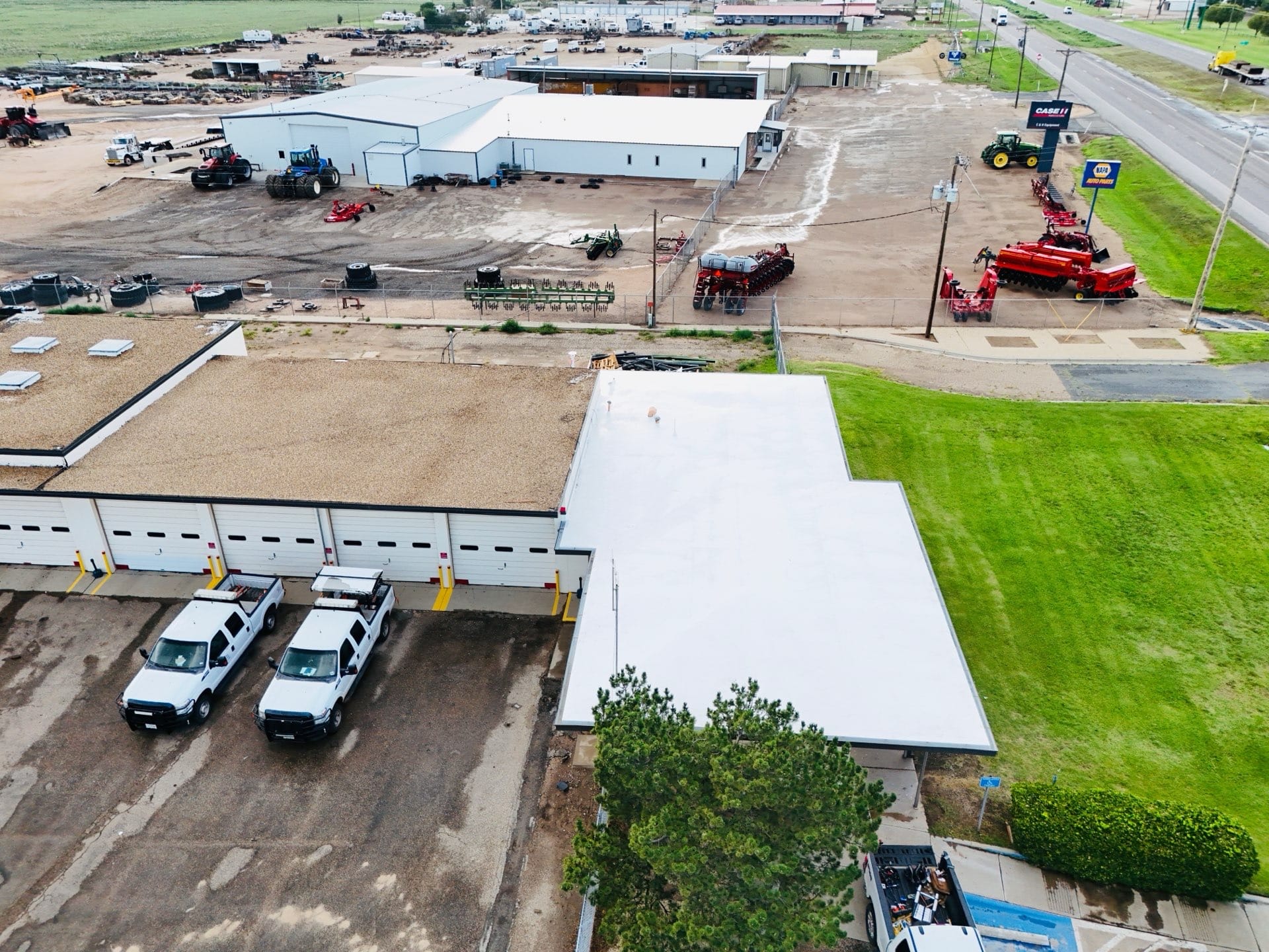 Aerial view of industrial buildings and vehicles.